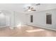 Neutral bedroom with ceiling fan, wood floors, and natural light at 16527 W Ironwood St, Surprise, AZ 85388