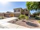 Exterior of house with a two-car garage, desert landscaping, and covered front porch at 16527 W Ironwood St, Surprise, AZ 85388