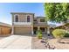 Charming two-story home with desert landscaping, a two-car garage, and a covered front porch at 16527 W Ironwood St, Surprise, AZ 85388