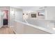 Upstairs hallway with open landing, white railing, and natural light at 16527 W Ironwood St, Surprise, AZ 85388