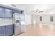 Modern kitchen featuring stainless steel refrigerator and navy cabinets, offering style and functionality at 16527 W Ironwood St, Surprise, AZ 85388