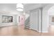 Bright, open-concept living space features wood floors, staircase, and a pink front door at 16527 W Ironwood St, Surprise, AZ 85388