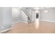 Open-concept living area with wood floors and a staircase at 16527 W Ironwood St, Surprise, AZ 85388