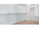 Bright walk-in closet with built-in shelving and wood-look flooring at 16527 W Ironwood St, Surprise, AZ 85388