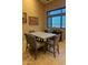 Inviting dining space with a large table, comfortable seating, and a serene view through the window at 16820 E La Montana Dr # 105, Fountain Hills, AZ 85268