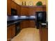 Well-equipped kitchen featuring wood cabinets, sleek black appliances, and ample counter space for cooking at 16820 E La Montana Dr # 105, Fountain Hills, AZ 85268