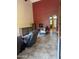 Bright living room with high ceilings, decorative cabinets, and archway to backyard at 16820 E La Montana Dr # 105, Fountain Hills, AZ 85268