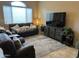 Relaxing living room with a plush sofa, decorative pillows, an entertainment center, and plenty of natural light at 16820 E La Montana Dr # 105, Fountain Hills, AZ 85268