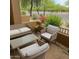 Comfortable patio area with a glass-top table, cushioned chairs, and view of well-maintained landscaping at 16820 E La Montana Dr # 105, Fountain Hills, AZ 85268