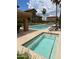 Inviting community pool area with lounge chairs, palm trees, and a separate jacuzzi at 16820 E La Montana Dr # 105, Fountain Hills, AZ 85268