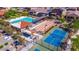 Aerial view of community amenities showcasing the pool, bocce ball, and tennis courts at 18021 W Avenida Del Sol --, Surprise, AZ 85387