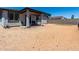 View of the backyard featuring a covered patio area and potential for landscaping or recreation at 18021 W Avenida Del Sol --, Surprise, AZ 85387