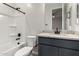 Bathroom with a gray vanity, a granite countertop, a tub, and a toilet at 18021 W Avenida Del Sol --, Surprise, AZ 85387