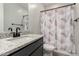 Modern bathroom featuring granite countertop, sleek fixtures, and a shower with a stylish curtain at 18021 W Avenida Del Sol --, Surprise, AZ 85387