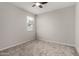 Bedroom featuring neutral walls, carpeted floors, a window, and a ceiling fan at 18021 W Avenida Del Sol --, Surprise, AZ 85387