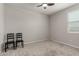 Bedroom featuring neutral walls, carpeted floors, a ceiling fan, and two chairs at 18021 W Avenida Del Sol --, Surprise, AZ 85387
