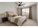 Comfortable bedroom featuring a large window with a ceiling fan and neutral decor at 18021 W Avenida Del Sol --, Surprise, AZ 85387