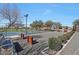 Bocce ball courts, tennis courts, and bench seating surrounded by mature trees at 18021 W Avenida Del Sol --, Surprise, AZ 85387