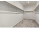 Walk-in closet featuring carpeted floors, white walls, and white shelving at 18021 W Avenida Del Sol --, Surprise, AZ 85387