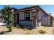 Close-up of the front entrance showcasing the stone accents and desert landscaping around the home at 18021 W Avenida Del Sol --, Surprise, AZ 85387