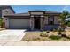 Charming single-level home featuring a stone-accented entrance, well-maintained landscaping, and a welcoming facade at 18021 W Avenida Del Sol --, Surprise, AZ 85387