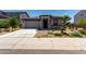 Beautiful single-story home with a two-car garage, stone accents, and desert landscaping in a tranquil neighborhood at 18021 W Avenida Del Sol --, Surprise, AZ 85387