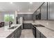 Gourmet kitchen featuring stainless appliances, granite counters, dark wood cabinets and convenient island at 18021 W Avenida Del Sol --, Surprise, AZ 85387