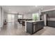 Island kitchen with granite countertops and stainless appliances is open to the dining and living spaces at 18021 W Avenida Del Sol --, Surprise, AZ 85387