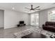 Relax in the living room, featuring wood-style floors, a ceiling fan and sliding glass doors to bring the outside in at 18021 W Avenida Del Sol --, Surprise, AZ 85387