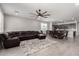 Spacious living room is open to dining and kitchen spaces, wood-style floors and contemporary ceiling fan at 18021 W Avenida Del Sol --, Surprise, AZ 85387