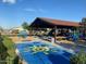 Community splash pad and playground for with secure fencing and seating areas at 18021 W Avenida Del Sol --, Surprise, AZ 85387