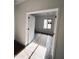 Sunlit bedroom with tile flooring, a bright window, and fresh white trim on the walls and door at 18165 W Larkspur Dr, Goodyear, AZ 85338