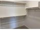 Walk-in closet with wall-to-wall shelving for organizing clothes and personal items, plus carpet flooring at 18165 W Larkspur Dr, Goodyear, AZ 85338