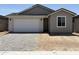 Charming single-Gathering home featuring a two-car garage and a well-maintained front yard with modern hardscape at 18165 W Larkspur Dr, Goodyear, AZ 85338