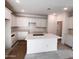 Bright kitchen featuring an expansive island, and white cabinets offering ample storage and counter space at 18165 W Larkspur Dr, Goodyear, AZ 85338
