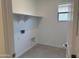 Bright laundry room with shelving and tiled floor, ready for appliances at 18165 W Larkspur Dr, Goodyear, AZ 85338
