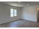 Bright, open living room with tile flooring, recessed lighting, and a large window offering plenty of natural light at 18165 W Larkspur Dr, Goodyear, AZ 85338