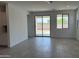 Bright, open living room featuring tile flooring, recessed lighting, and sliding glass door access to the backyard at 18165 W Larkspur Dr, Goodyear, AZ 85338