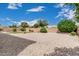 Large backyard with stone and manicured landscaping, perfect for a relaxing outdoor retreat at 1915 S Ponderosa Dr, Gilbert, AZ 85295