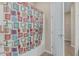 Bright bathroom with a colorful shower curtain and tile flooring near the entry at 1915 S Ponderosa Dr, Gilbert, AZ 85295