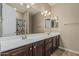 Bathroom with a long, mirrored vanity, plenty of counter space, and a shower at 1915 S Ponderosa Dr, Gilbert, AZ 85295