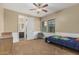 Bedroom with a ceiling fan, closet, a window with blinds, and view to the attached bathroom at 1915 S Ponderosa Dr, Gilbert, AZ 85295