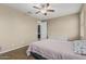 Cozy bedroom featuring a ceiling fan, a closet, a nightstand, and a dresser at 1915 S Ponderosa Dr, Gilbert, AZ 85295