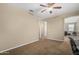 Neutral bedroom with a ceiling fan and carpet, hallway can be seen at 1915 S Ponderosa Dr, Gilbert, AZ 85295
