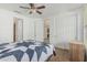 Bright bedroom featuring a ceiling fan, closet, and a view to the hallway at 1915 S Ponderosa Dr, Gilbert, AZ 85295