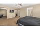 Large primary bedroom with neutral carpet, ceiling fan, and an open layout leading to a Primary bath at 1915 S Ponderosa Dr, Gilbert, AZ 85295