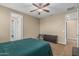 Bedroom featuring ceiling fan, walk-in closet, and a view to the hallway at 1915 S Ponderosa Dr, Gilbert, AZ 85295
