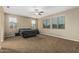 Bright bedroom with large windows, ceiling fan, neutral carpet, and a comfortable atmosphere at 1915 S Ponderosa Dr, Gilbert, AZ 85295