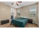 Cozy bedroom with a window, ceiling fan and a door to the walk-in closet at 1915 S Ponderosa Dr, Gilbert, AZ 85295