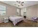 Cozy bedroom featuring a window, ceiling fan, closet, and a chair at 1915 S Ponderosa Dr, Gilbert, AZ 85295